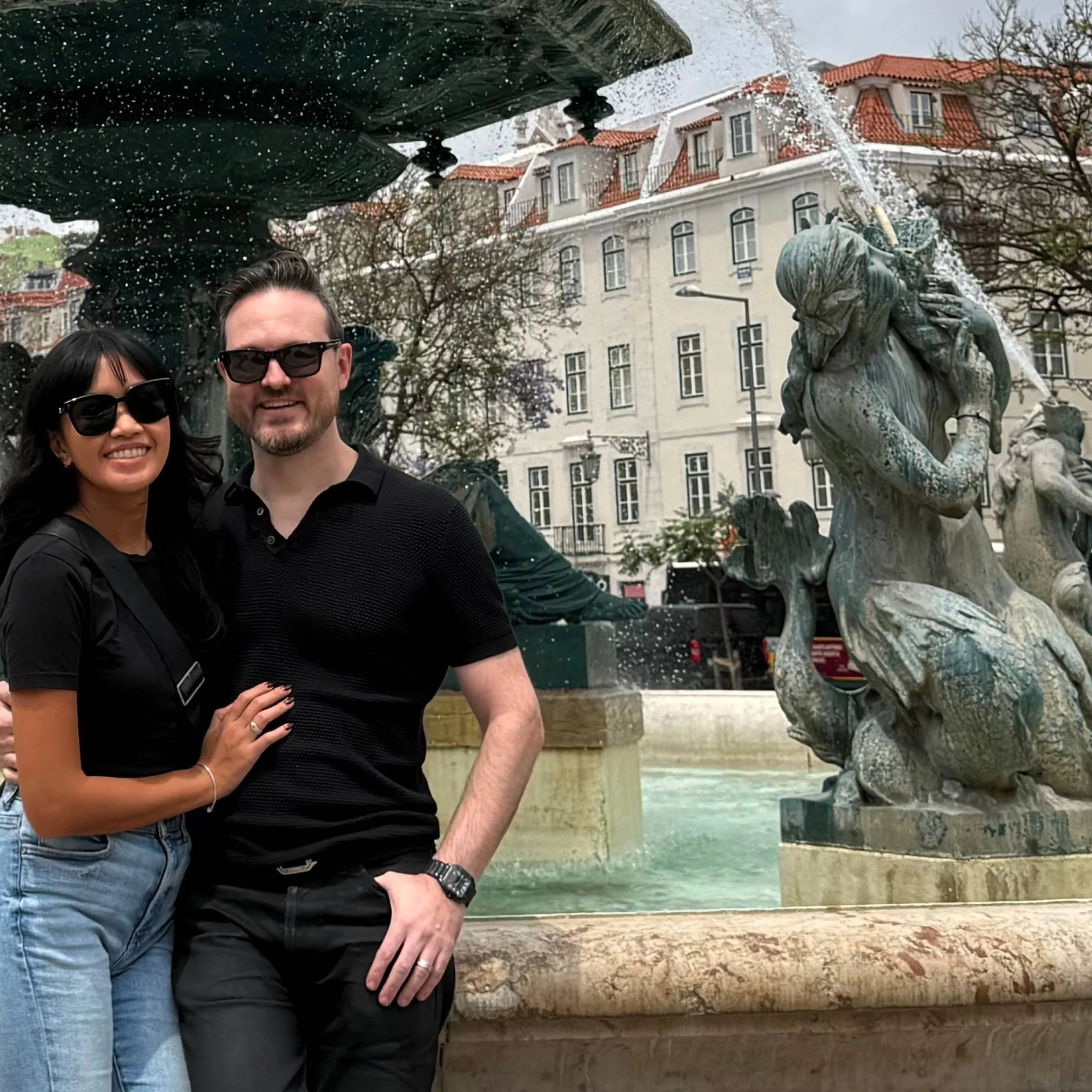 Jesse and Janine Schoberg by the fountain at Rossio Square in Lisbon