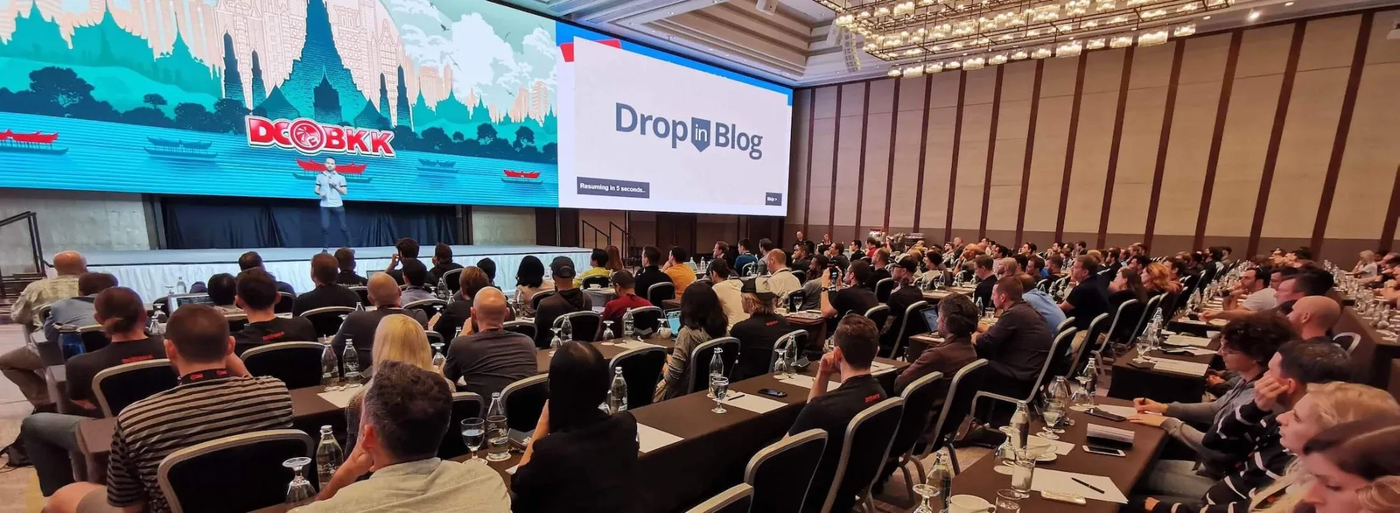 Jesse Schoberg speaking on stage at DCBKK in Bangkok