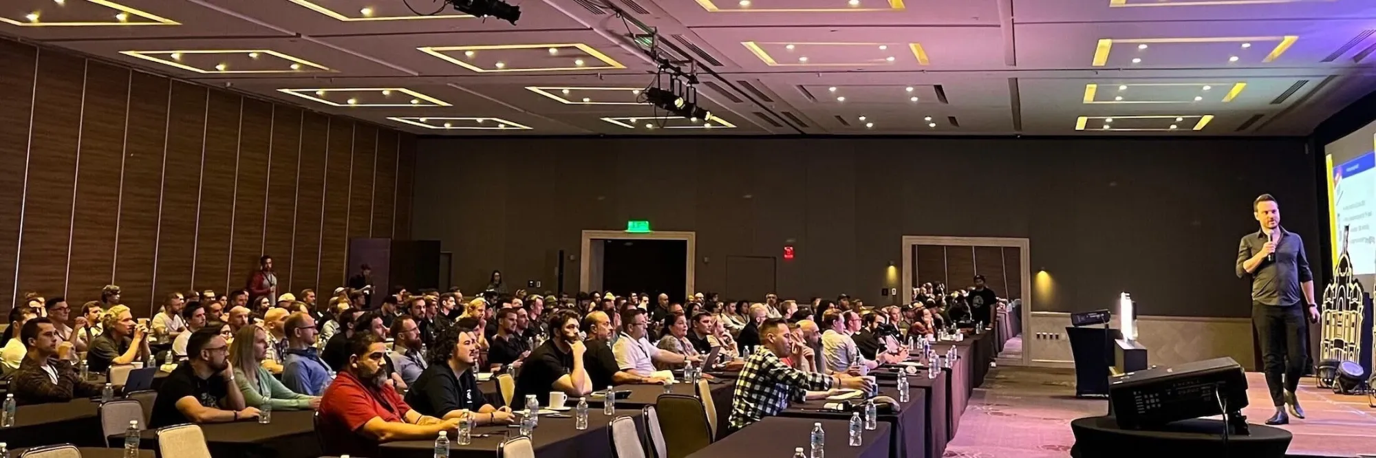 Jesse Schoberg speaking on stage at DCMEX
